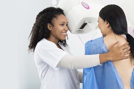 Nurse with a patient performing a breast cancer screening